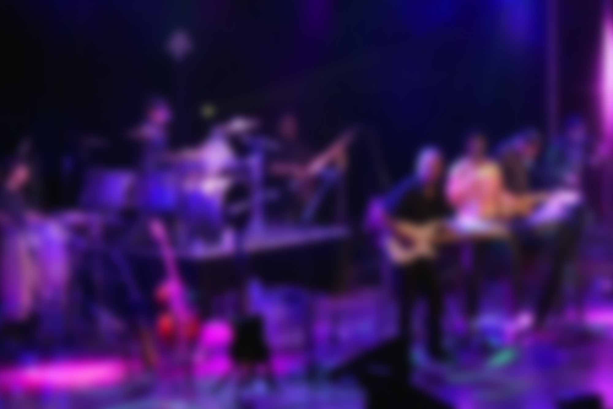 Blurred background image of War the Band singing live